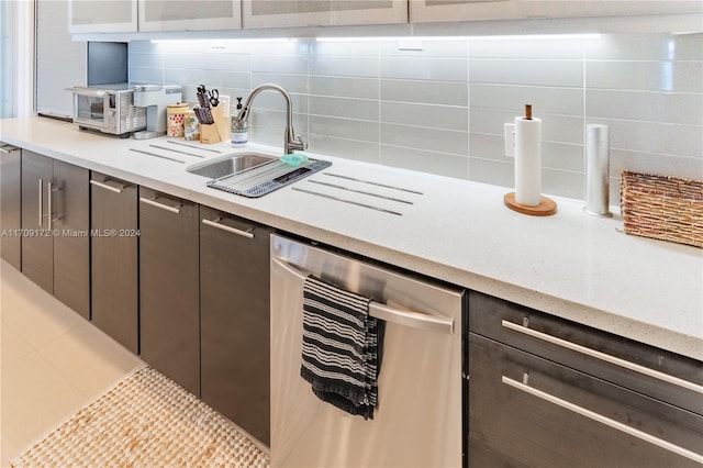 kitchen featuring backsplash, dark brown cabinetry, sink, and beverage cooler