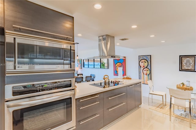 kitchen with island range hood and appliances with stainless steel finishes