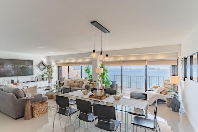 dining room with a water view and light tile patterned floors