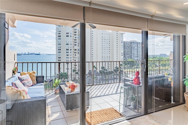 balcony featuring outdoor lounge area and a water view