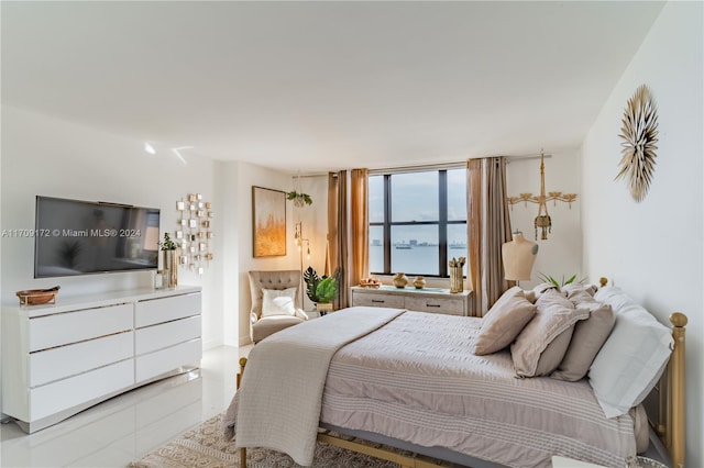 tiled bedroom featuring a water view