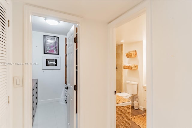 hallway with tile patterned floors