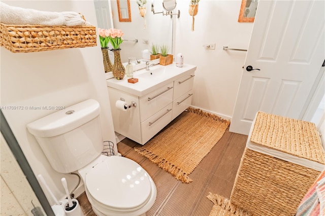 bathroom featuring hardwood / wood-style floors, vanity, and toilet