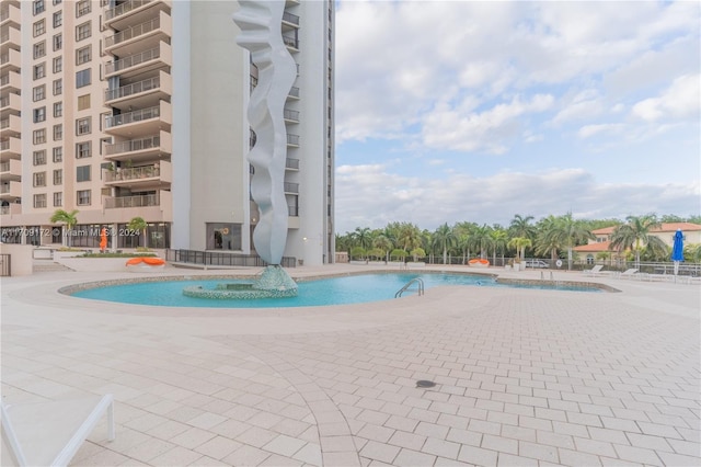 view of swimming pool with a patio