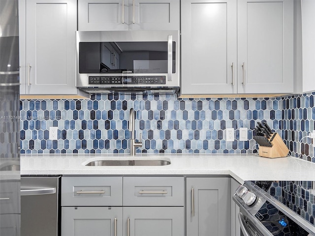 kitchen featuring tasteful backsplash, sink, and stainless steel appliances