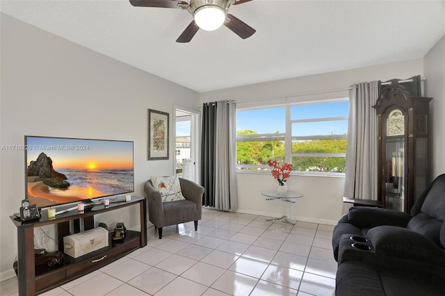 living area with ceiling fan and light tile patterned flooring