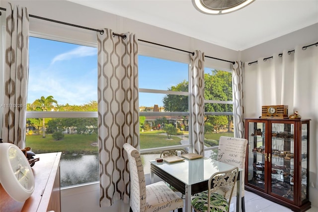 sunroom / solarium featuring plenty of natural light and a water view