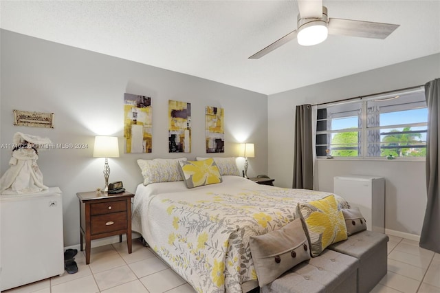 tiled bedroom featuring ceiling fan