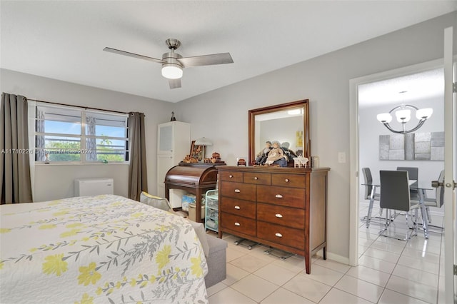 tiled bedroom featuring ceiling fan with notable chandelier