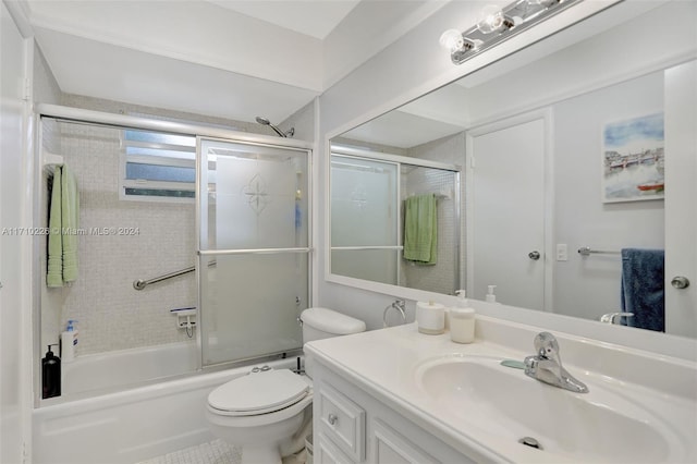 full bathroom with vanity, enclosed tub / shower combo, and toilet