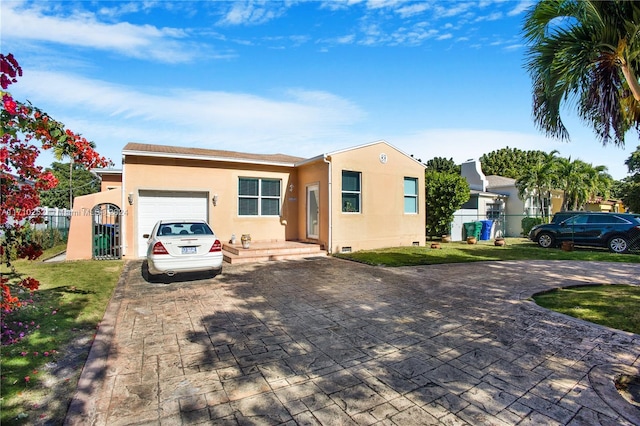 view of front of property with a front yard and a garage