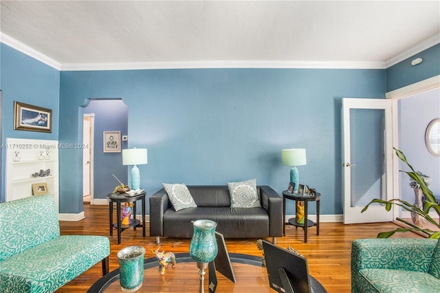 living room featuring crown molding and hardwood / wood-style floors