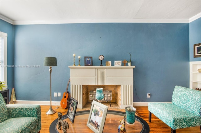 sitting room featuring crown molding and wood-type flooring