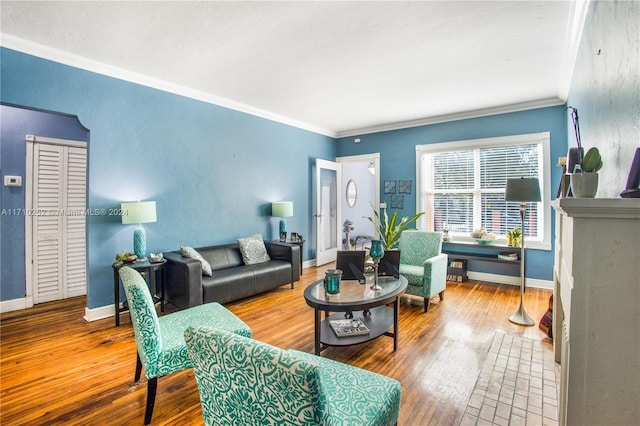 living room with hardwood / wood-style flooring and ornamental molding