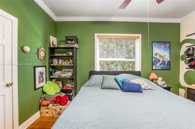 bedroom featuring hardwood / wood-style flooring, ceiling fan, and crown molding