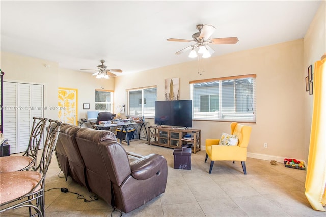 living room featuring ceiling fan and light tile patterned flooring