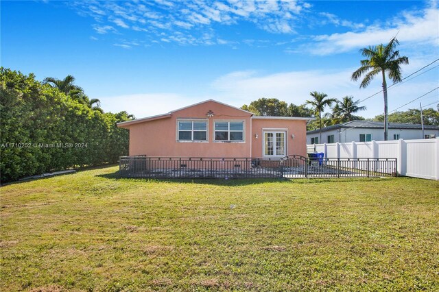 rear view of house with a yard