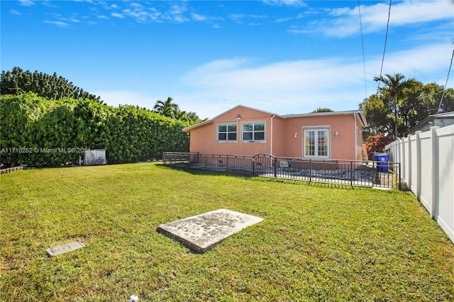 view of yard featuring french doors