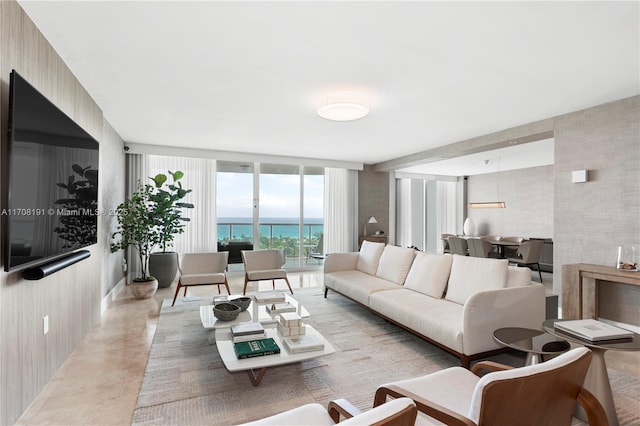 living area featuring floor to ceiling windows and a water view