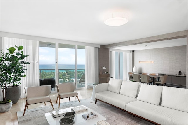 living area featuring a water view and expansive windows