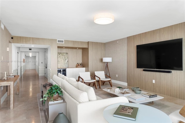 living area featuring wine cooler and visible vents