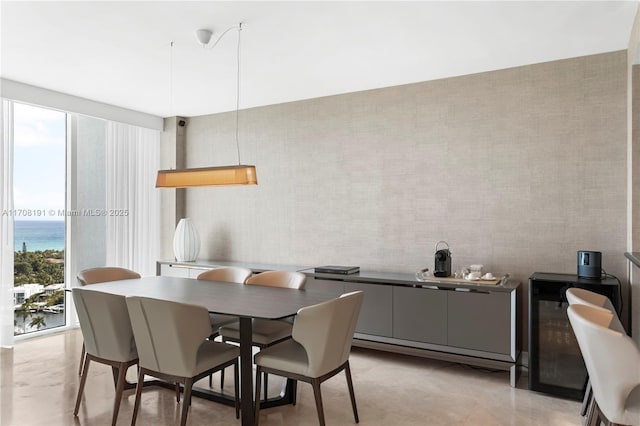 dining space with a water view and plenty of natural light