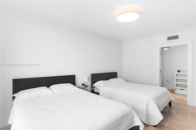 bedroom with ornamental molding and visible vents