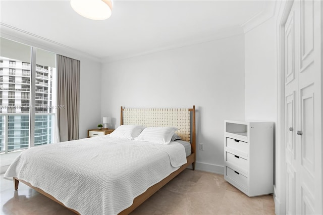 bedroom featuring ornamental molding and baseboards