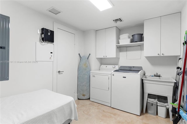 laundry area with visible vents, washing machine and clothes dryer, and cabinet space