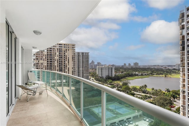 balcony featuring a view of city and a water view