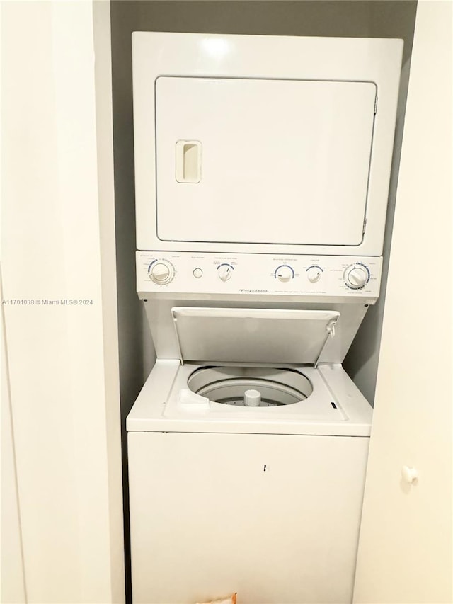 clothes washing area with stacked washer and clothes dryer