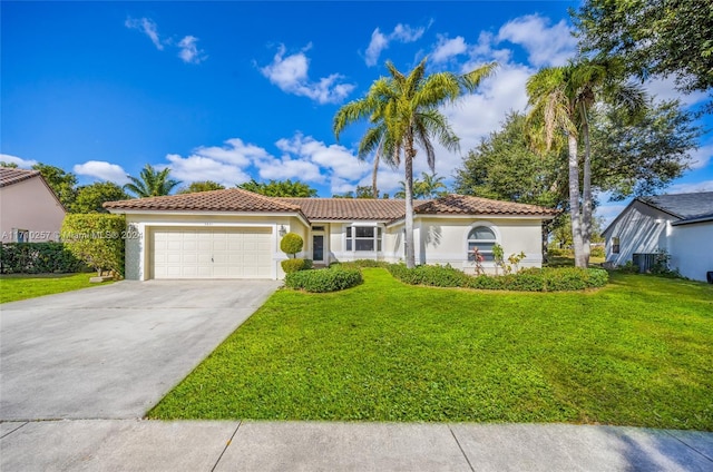 mediterranean / spanish-style house with a front yard and a garage