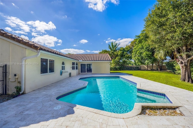 view of swimming pool featuring a patio and a lawn