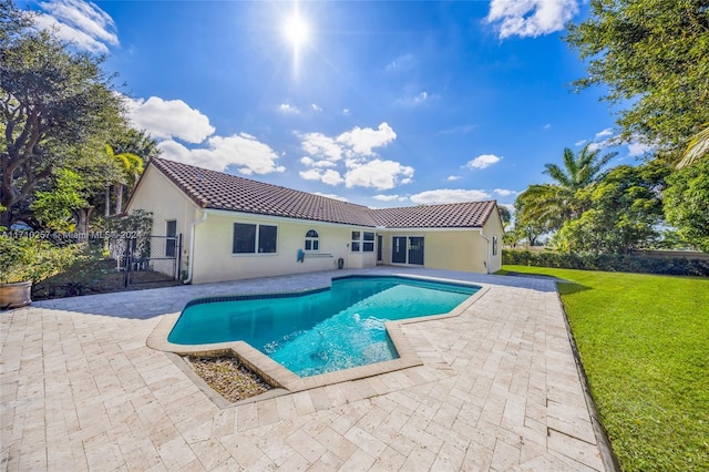 view of swimming pool featuring a patio area and a yard