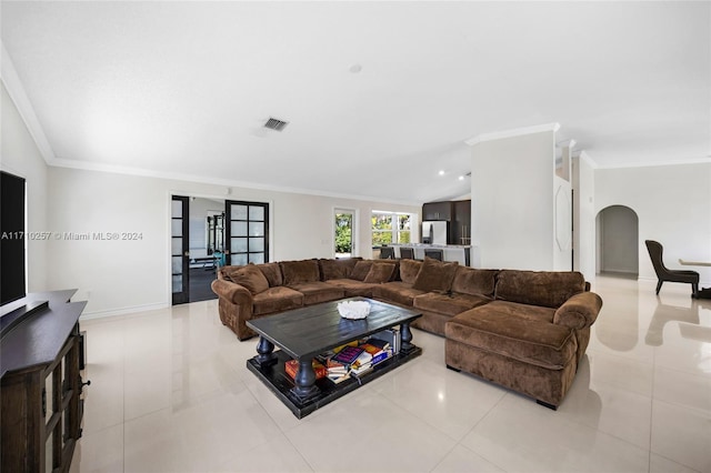 living room featuring light tile patterned floors, french doors, and crown molding