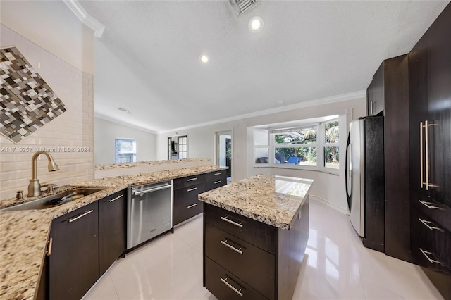 kitchen featuring a healthy amount of sunlight, sink, appliances with stainless steel finishes, and vaulted ceiling