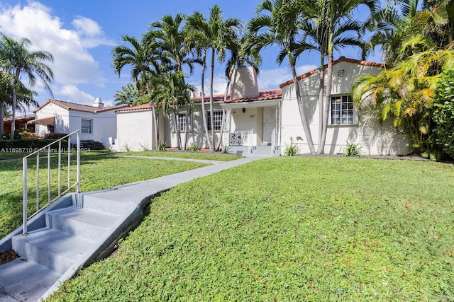 mediterranean / spanish-style home featuring a front lawn