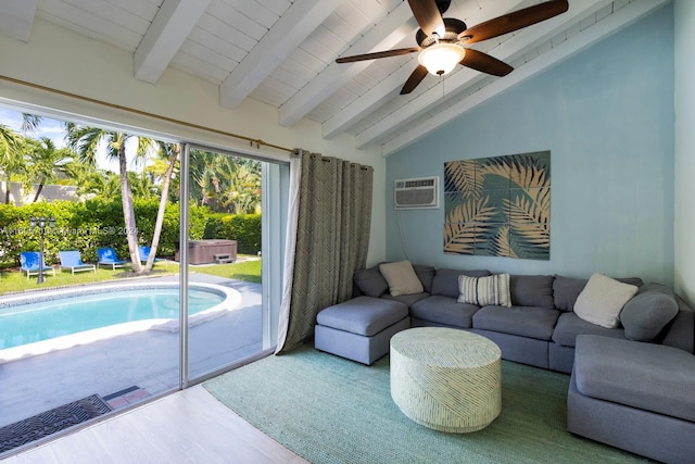 living room featuring wood-type flooring, lofted ceiling with beams, an AC wall unit, and ceiling fan