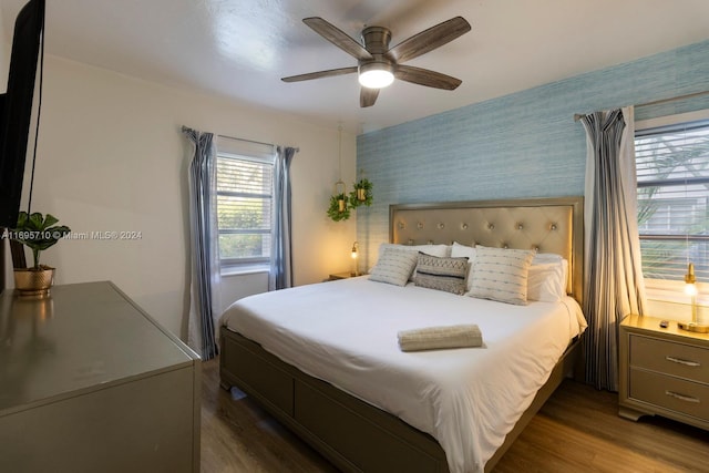 bedroom with ceiling fan and dark hardwood / wood-style flooring