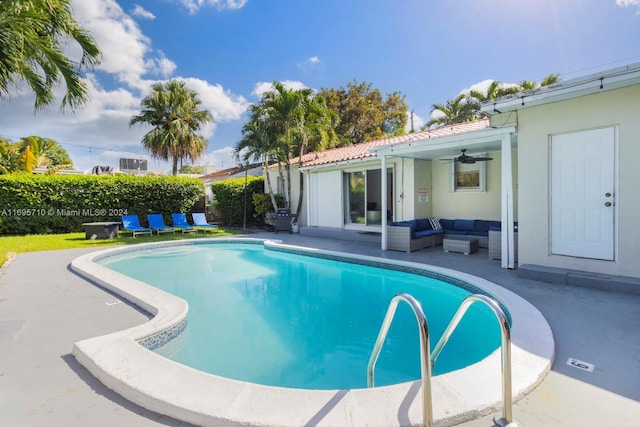 view of swimming pool featuring ceiling fan and a patio area