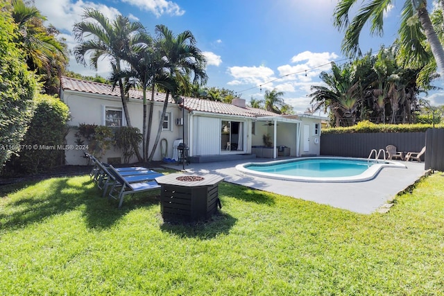 view of pool featuring a lawn, a patio area, and ceiling fan