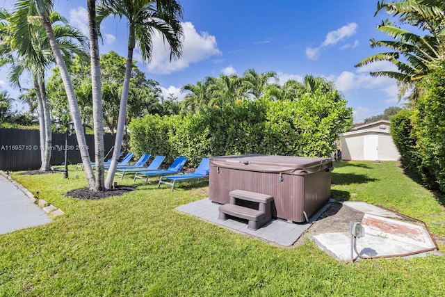 view of yard with a hot tub and a storage shed