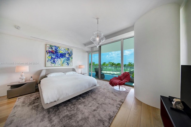 bedroom with ceiling fan, access to exterior, and light hardwood / wood-style flooring