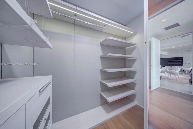 spacious closet featuring light hardwood / wood-style floors