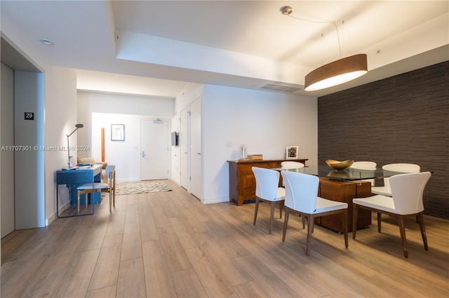 interior space with light wood-type flooring and elevator