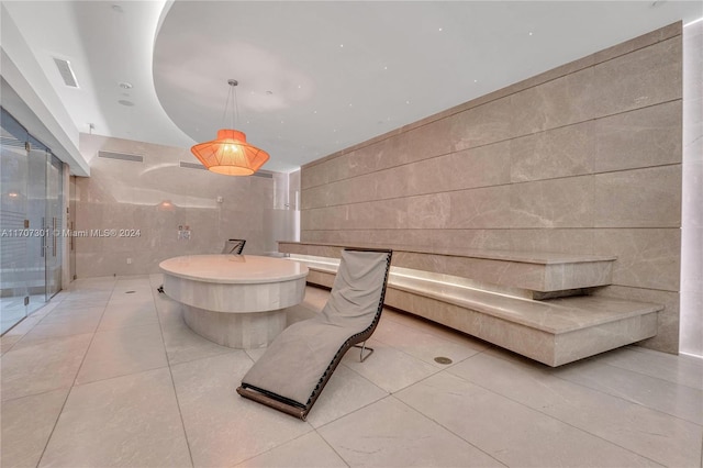 bathroom with tile patterned flooring and tile walls