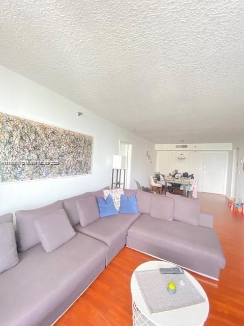 living room featuring hardwood / wood-style floors and a textured ceiling