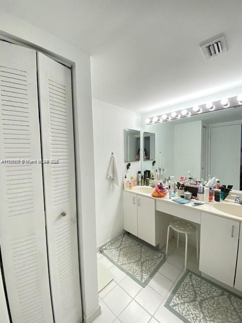 bathroom with tile patterned flooring and vanity