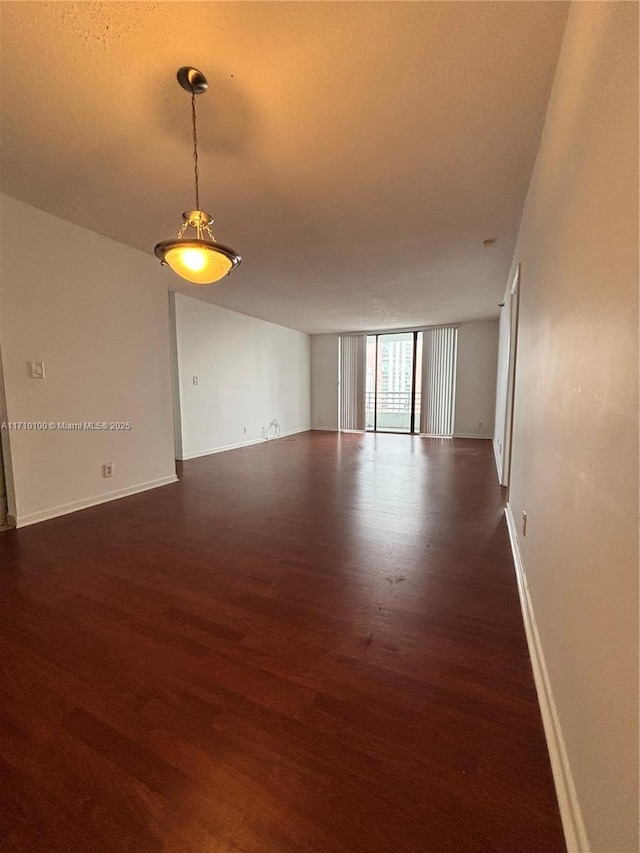 unfurnished room featuring dark hardwood / wood-style flooring