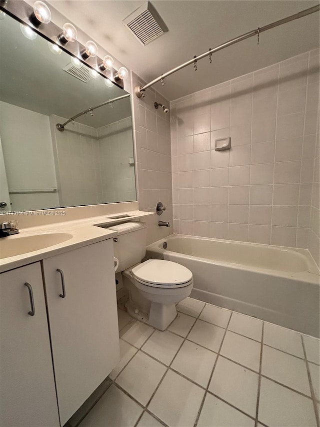 full bathroom with tiled shower / bath, vanity, toilet, and tile patterned flooring